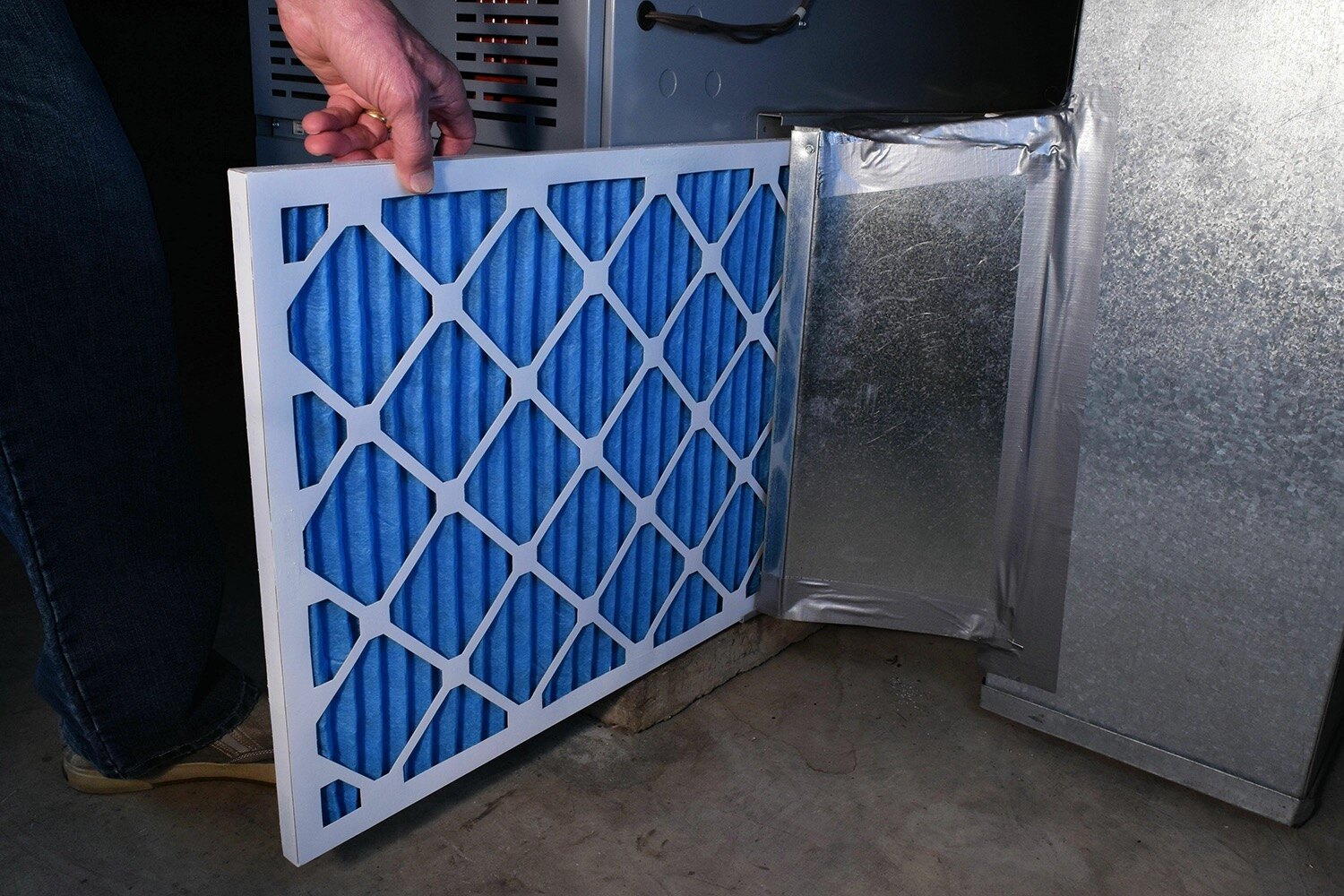 A furnace filter pulled from the cabinet